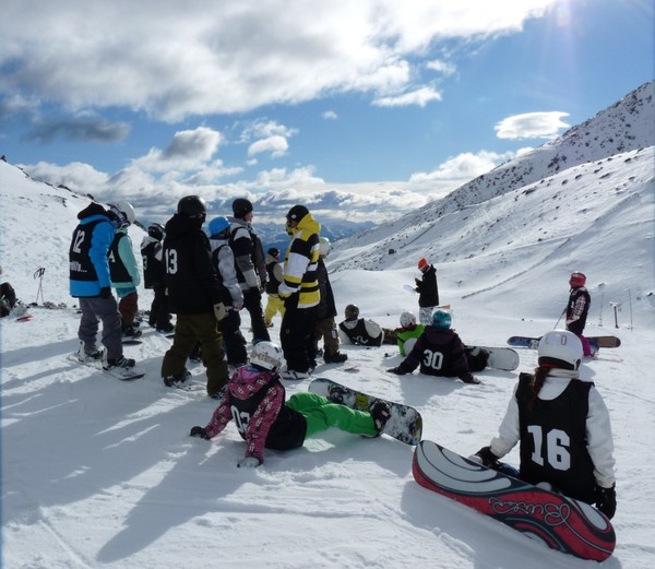 A group of skiers and riders wait for their chance to shine at the top of the Tararua Real Ice Coffee (TRIC) Beginner Park in the 2009 Parklife Youth Mini Shred Competition series.